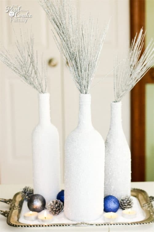 I love wine bottle crafts! This is a tutorial to make this beautiful and inexpensive diy wine bottle centerpiece. Perfect winter home decor!!