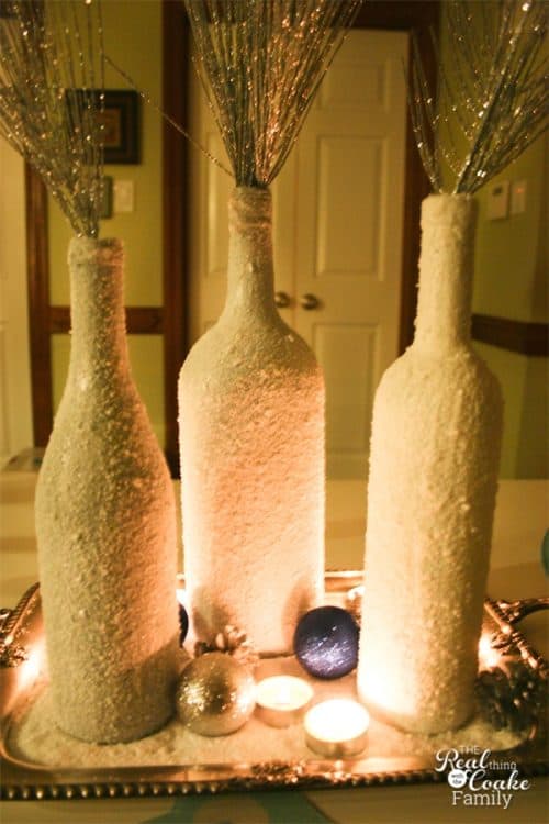 I love wine bottle crafts! This is a tutorial to make this beautiful and inexpensive diy wine bottle centerpiece. Perfect winter home decor!!