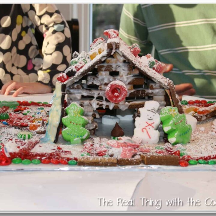 log cabin style gingerbread house decorated with candy