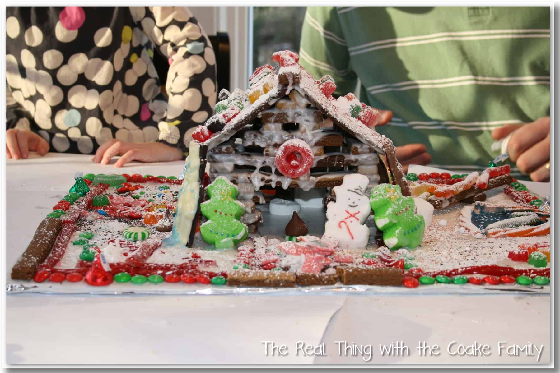 log cabin style gingerbread house decorated with candy