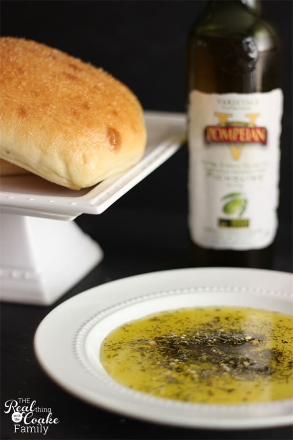 Quick, simple, and delicious Olive Oil and herb dip served with an olive oil and sea salt crusted bread. Delish! #PompeianVarietals #OliveOil #Recipe #Appetizer #Bread #RealCoake #Ad
