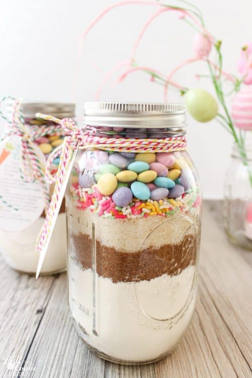 OM to the Cuteness! This M&M Cookie Recipe in a Mason Jar is so cute and the cookies are so delicious. These are fun, unexpected Easter gifts for friends or family or my family. 