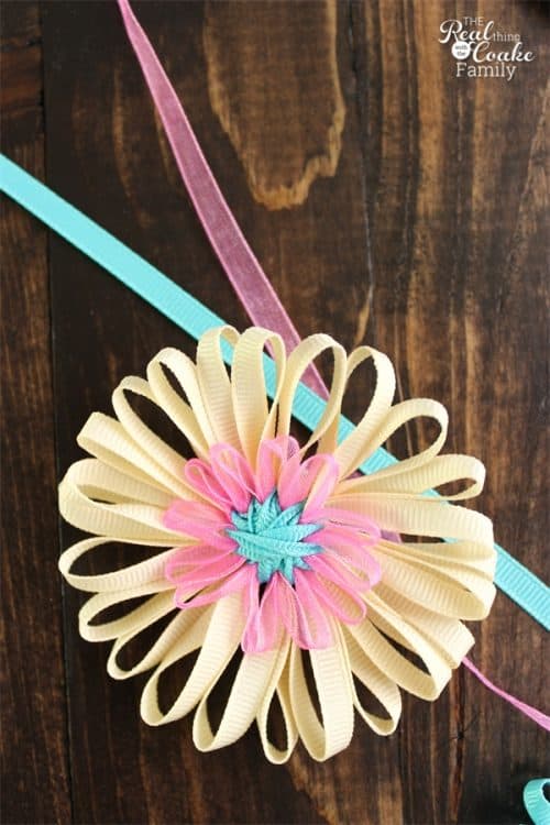 These double layer flowers made with ribbon are such an easy and fun crafts! Full tutorial on how to take Ribbon and create a Flower.