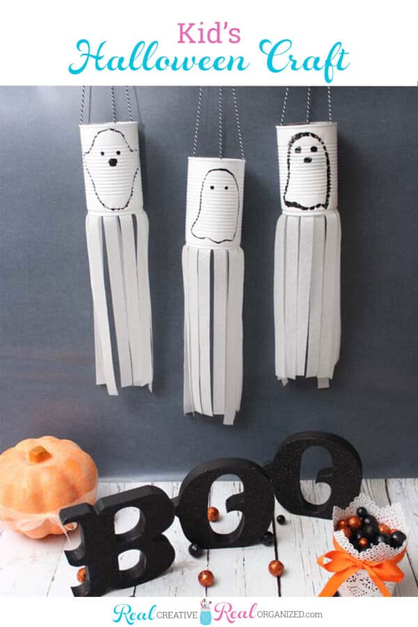 3 ghosts made out of recycled aluminum cans in a Halloween kids craft