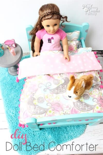These doll bed comforters are so adorable! I love sewing cute things for our American Girl Dolls. The pom pom trim just makes these so cute!