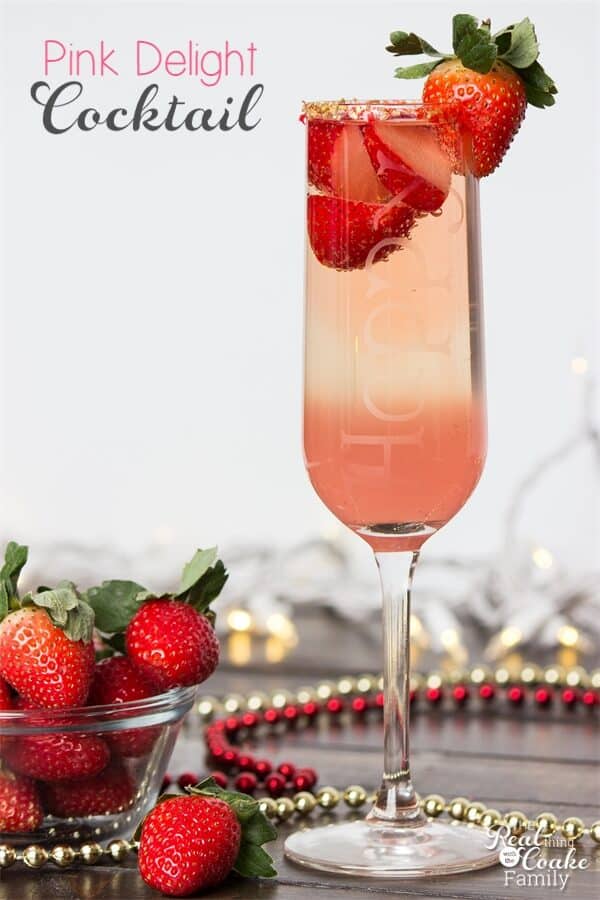 pink wine cocktail recipe in champagne flute with strawberries on top