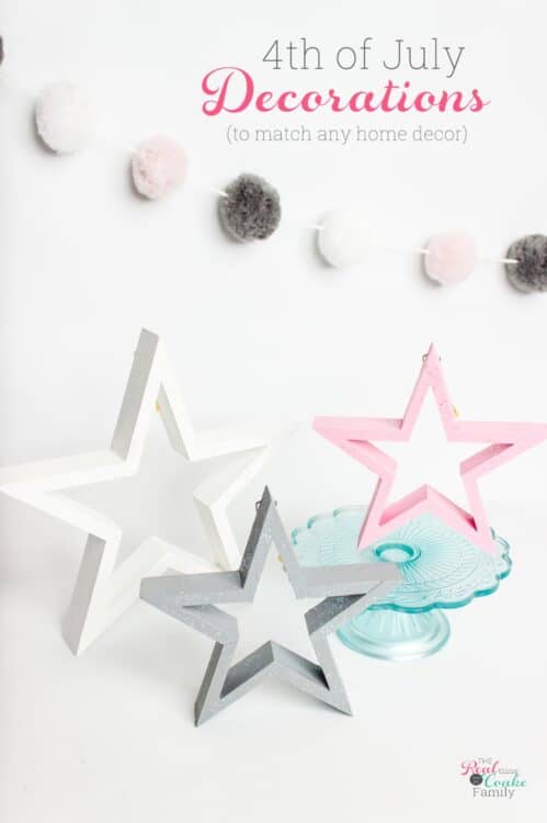 3 wood stars painted with white, pink, and gray paint and glitter paint.