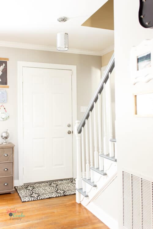hallway with grey and white painted staircase