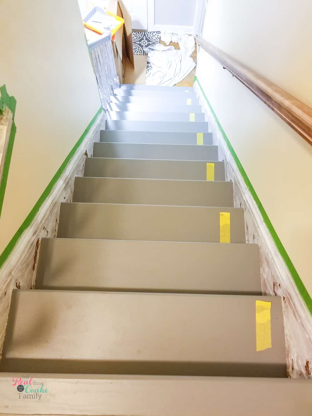delicate painters tape on every other tread to show where to walk when painting stair treads