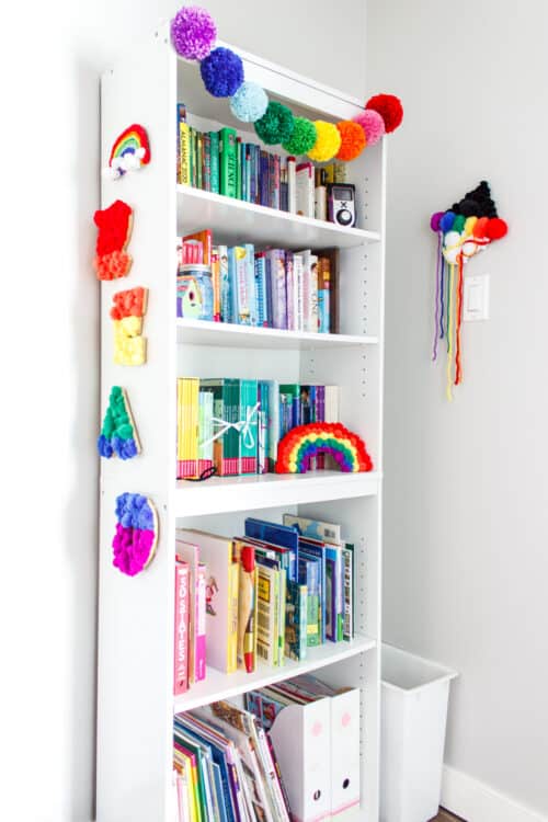 white bookshelf with rainbow decorations