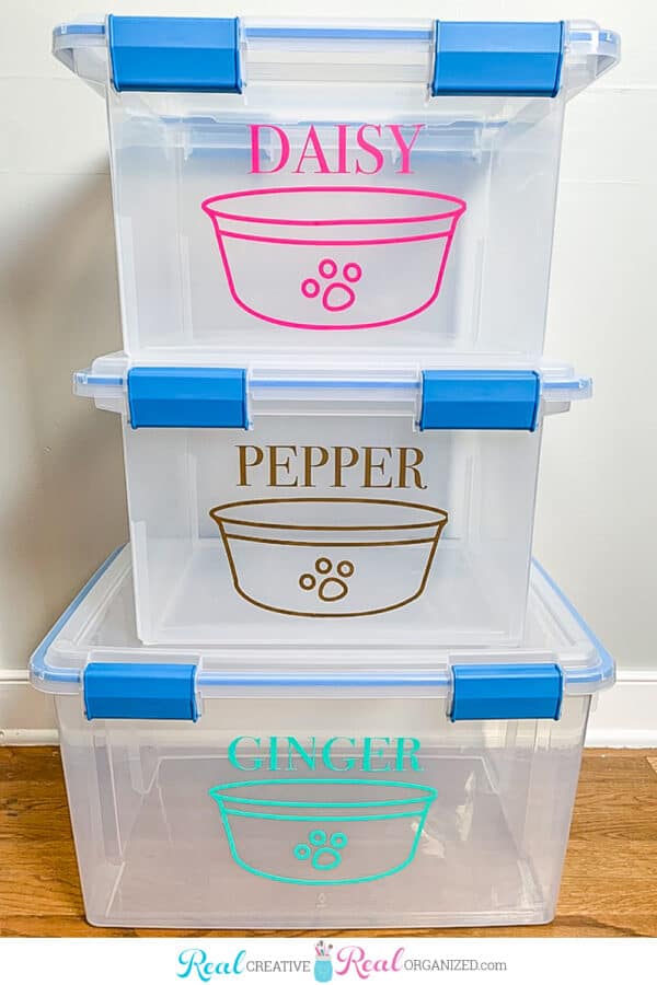 Stack of pet food storage bins labeled for each dog or cat