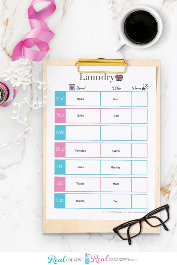laundry schedule printable on clipboard filled out with loads and who is completing them